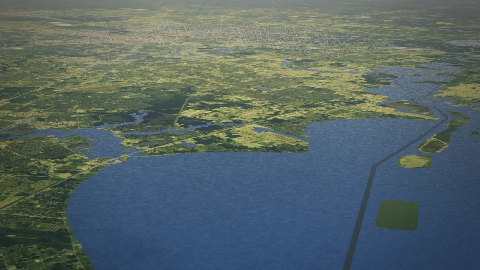 Galveston Bay seen from high above in the morning, the Houston region beyond it as a photographic patchwork of fields, towns and bayous.