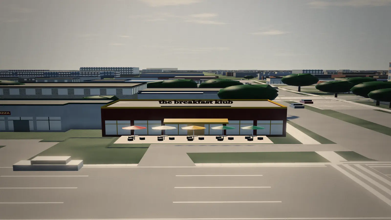 The Breakfast Klub rebuilt on its block: a low building with its name on the sign band, patio umbrellas out front, a striped lot and the street in the foreground.